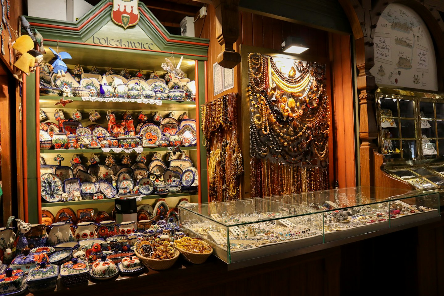 Handcrafted pottery and amber jewelry displayed in an artisan shop.